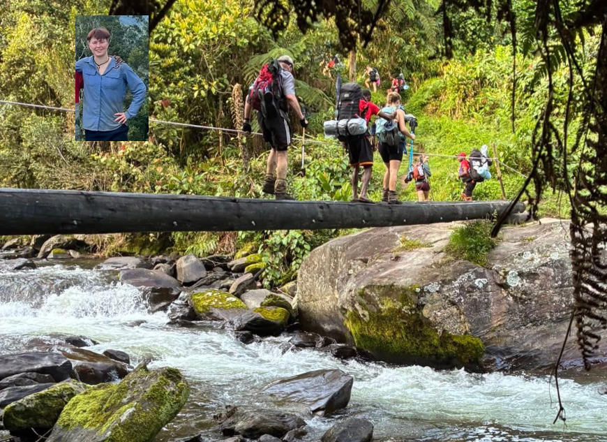 Party of walkers crossing a log bridge in the jungle
