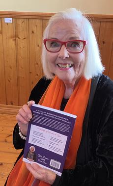 Tricia Dennis with her book