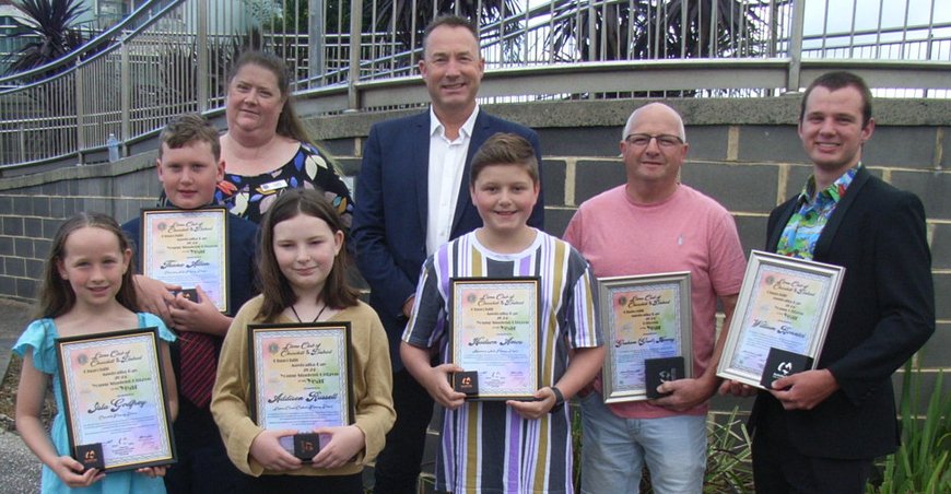 Award recipients showing their awards