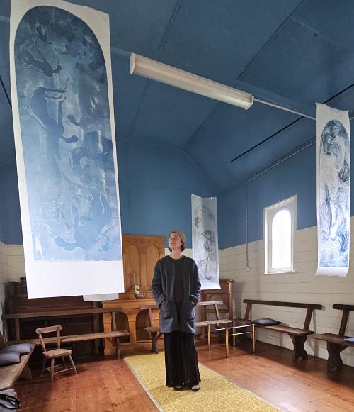 Dana Flahavin views the hangins in the church