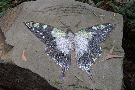 Mosaic of butterfly set into boulder