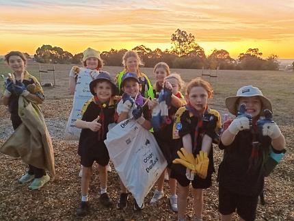 Cub Scouts showing their gloves and litter bags