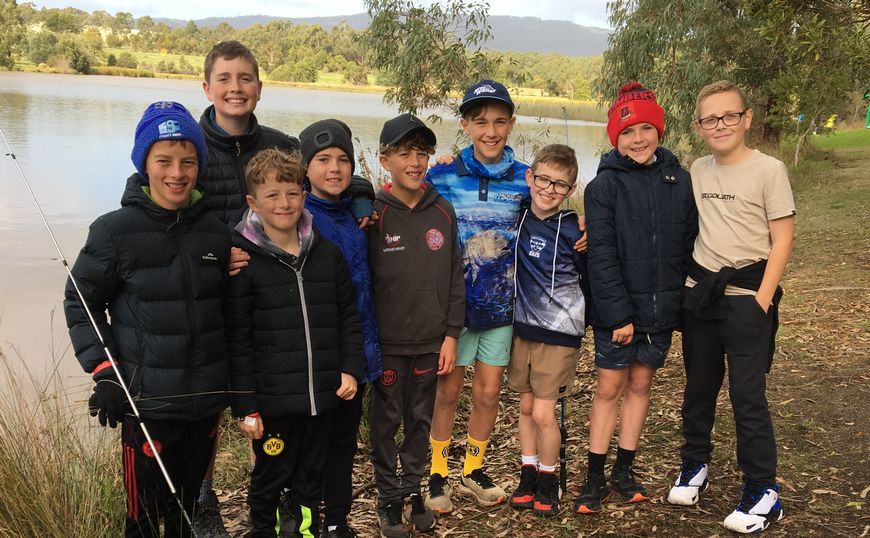 Kids posing for photo in front of Lake Hyland