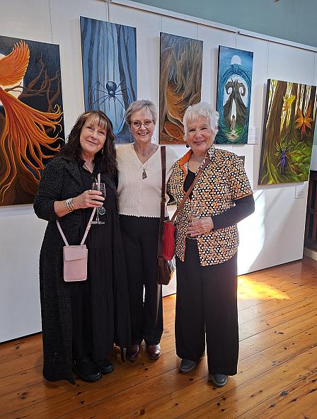 Artists standing infront of various artworks