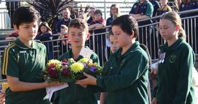 Lumen Christie Primary students laying wreath