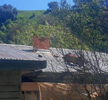 Earthquake showing broken chimney on house